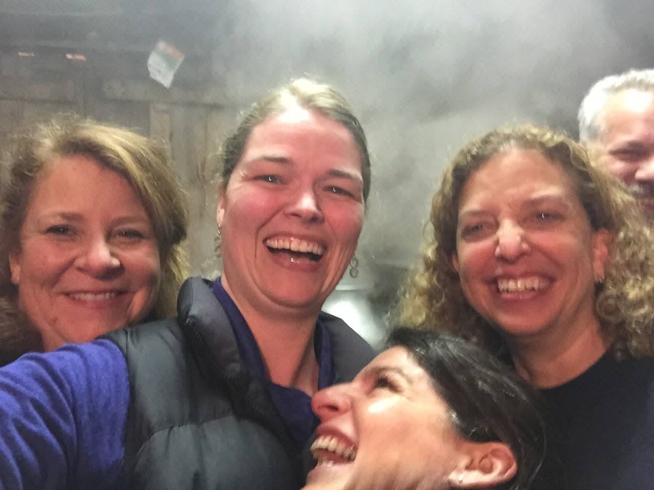 Smiling faces together in the steam-filled Knolltop Farm sugarhouse